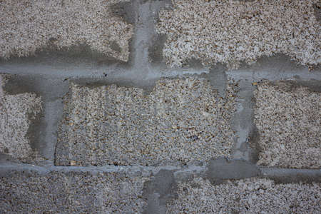 The texture of the wall of an unfinished house with large blocks and plaster. Background
