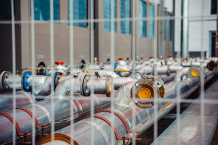 Gas pipes behind a fence.の写真素材
