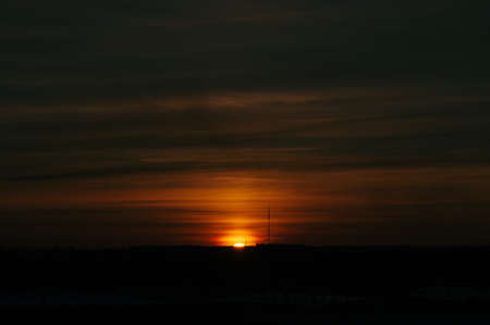 The sky at sunrise. Silhouettes of structures.の写真素材