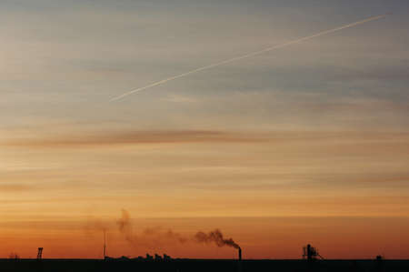 The sky at sunrise. Silhouettes of structures.の写真素材