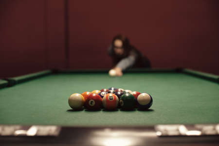 American billiard poule. Shot of a man playing billiard. Triangle of billiard balls. の写真素材
