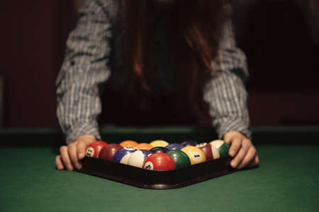 American billiard poule. Triangle of billiard balls. A man getting ready to start a game of billiards.の写真素材