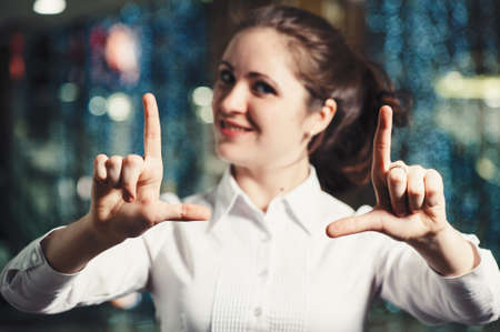 Business woman gesturing with hands in office close-up. Classic business. Interactive touch panel.の写真素材