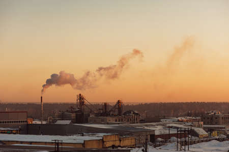 Industrial buildings at sunrise. Warehouses. Smoke from the pipe. Gradient.の写真素材