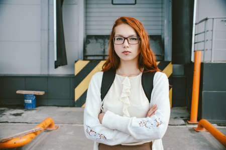 Portrait of a red-haired girl in red glasses.の写真素材