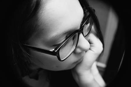 Black and white portrait of a girl close-up. Distortion. View from above.の写真素材