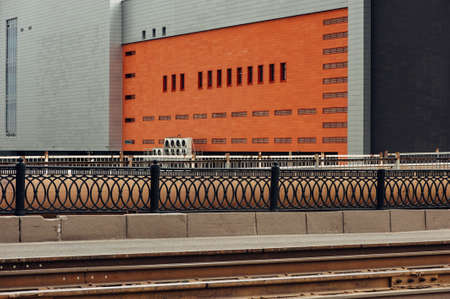 A large gray building with an orange wall. Colorful city. Empty.の写真素材