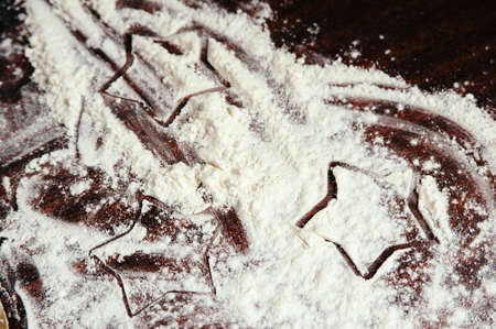 Painted stars on flour scattered on the table close up.の写真素材