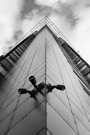 Corner side of a residential house against the sky. Monochrome image.