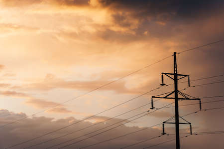 Electric pole on the background of the setting sun.の写真素材
