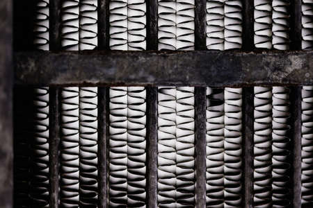Old, rusty automotive cooler. Rusty, red lattice texture. Grid.の写真素材
