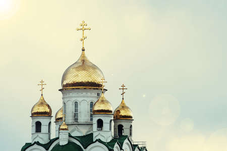Christian church against the blue sky. Golden domes. Facade.の写真素材