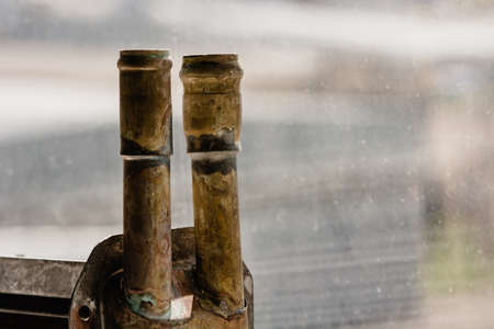 Copper pipes on the background of glass, pointing up.の写真素材