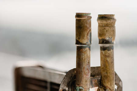 Copper pipes on the background of glass, pointing up.の写真素材