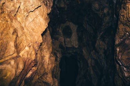 The beginning of the underground tunnel. Entrance to the dark cave.の写真素材