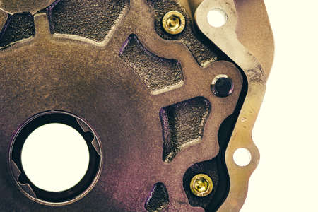 Metal part with a round hole and screws close-up.の写真素材