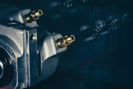 Part of the complex mechanism close-up on a background of a dirty glass.