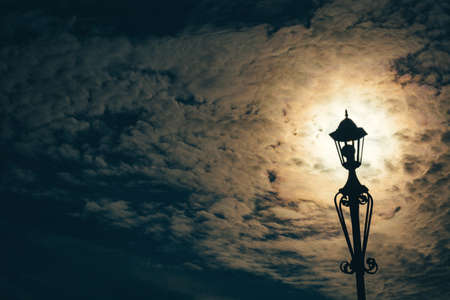 Silhouette of a lantern in a cloudy skyの写真素材