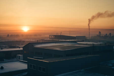 Industrial buildings at sunrise. Warehouses. Smoke from the pipe. Gradient.の写真素材