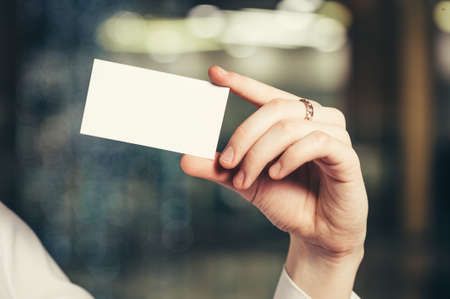 A woman's hand with a business card.の写真素材