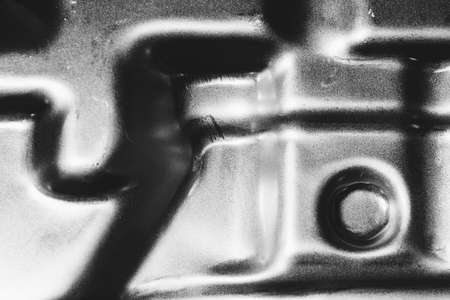 Monochrome metal background from beautiful silver auto part close up.の写真素材
