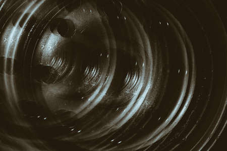 Monochrome multi exposition background of oil filter close up. Artwork from auto part in macro photography. の写真素材