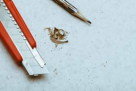 Table composition with pencil, cleric knife and shavings. Copy space.の写真素材