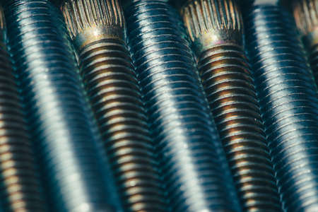 Background from automotive bolts in blue and yellow tones close up.の写真素材