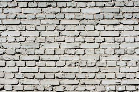 Old realistic brick wall made of white brick. White uneven brickwork.