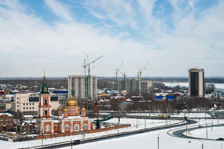 Znamensky temple against backdrop of build buildings. Cityscape of Barnaul with church and high-rise buildings, shot from height, 28 March 2018. Barnaul, Russia. View from upland park.のeditorial素材