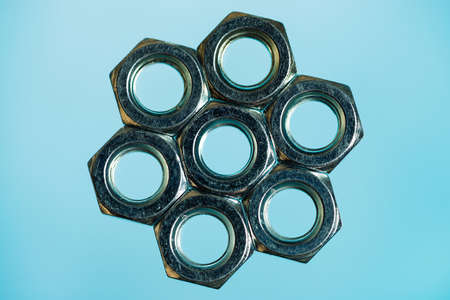 Hexagon from nuts on cyan background close up.