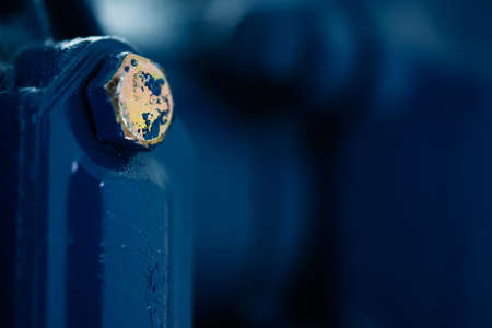 Blue metal rough surface of part with gold bolt. Blue painted of auto part. Automotive grunge background image.の写真素材