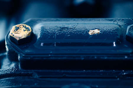 Blue metal rough surface of part with gold bolt. Blue painted of auto part. Automotive grunge...