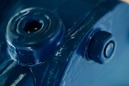 Blue metal rough surface of part with bolts and nuts. Blue painted of auto part. Automotive grunge...