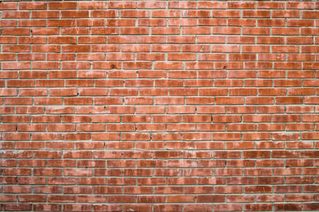 Old realistic brick wall made of red brick in different shads. Brown smooth brickwork.