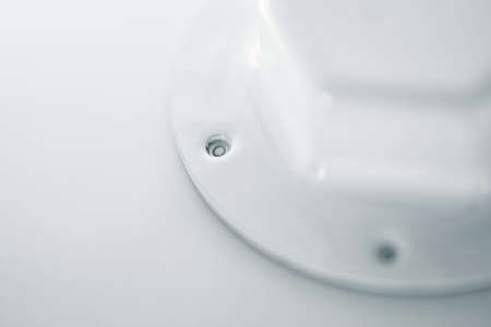 Background image of white oil filter close-up. Artwork from auto part in macro photography. White metal texture.の写真素材