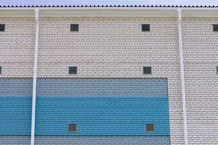 Wall of cooperative building for store, workshop, garage and other industrial needs. Background from...