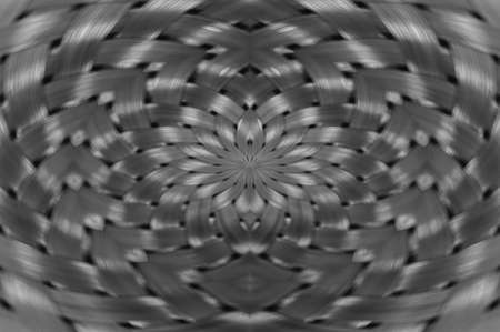 Symmetrical silver metallic wicker texture close-up. Detail background of volume steel surface. Abstract gray braided wire in macro. Surreal shape with copy space. Unusual black and white space.の写真素材