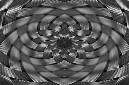 Symmetrical silver metallic wicker texture close-up. Detail background of volume steel surface. Abstract gray braided wire in macro. Surreal shape with copy space. Unusual black and white space.の写真素材