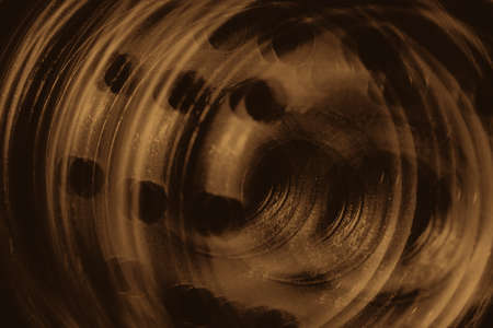 Monochrome multi exposition background of oil filter close up. Artwork from auto part in macro photography. Sepia tones.の写真素材