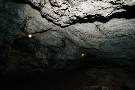 Beautiful cave. View from inside dark dungeon. Textured walls of cave. Background image of...