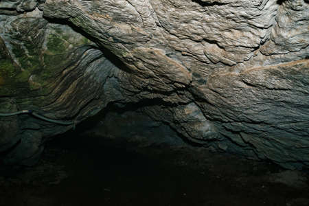 Beautiful cave. View from inside dark dungeon. Textured walls of cave. Background image of...