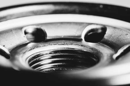 Monochrome background image of oil filter close up. Art macro photography of auto part in grayscale.