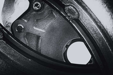 Unusual robotic eye in steampunk style in grayscale. Focused robot look. Monochrome background pattern close-up.の写真素材