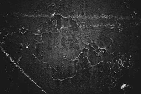 Black-white vintage art background. Texture of decorative grunge stucco. Monochrome book cover. Spotted scratched wall close-up. Backdrop of painted plaster in macro. Artwork plate in grayscale.の写真素材