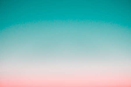 Surreal predawn clear sky with pink horizon and green atmosphere. Smooth pink green gradient of dawn sky. Background of day beginning. Heaven at early morning with copy space. Sunset, sunrise backdropの写真素材