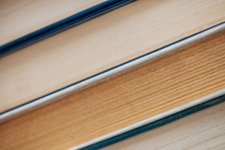 Vintage books close-up. Stack of used old literature in school library. Background from old chaotic reading matter. Dusty faded books diagonally with copy space. Old book store.の写真素材