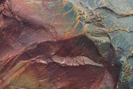 Plane of multicolored boulder in macro. Beautiful rock surface close up. Colorful textured stone....