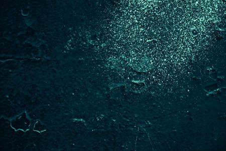 Vintage azure background. Rough painted wall of turquoise color. Imperfect plane of cyan colored. Uneven old decorative toned backdrop of aqzure tint. Texture of teal hue. Ornamental stony surface.の写真素材