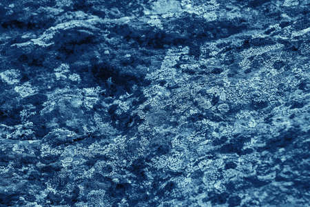 Vintage blue background. Rough painted wall of sapphire color. Imperfect plane of blue colored....